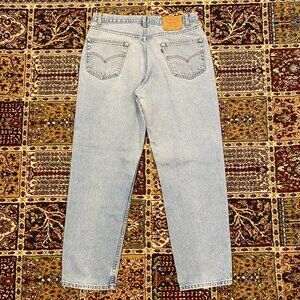 Vintage 90s Levi's 550 Relaxed Tapered fit light wash jeans